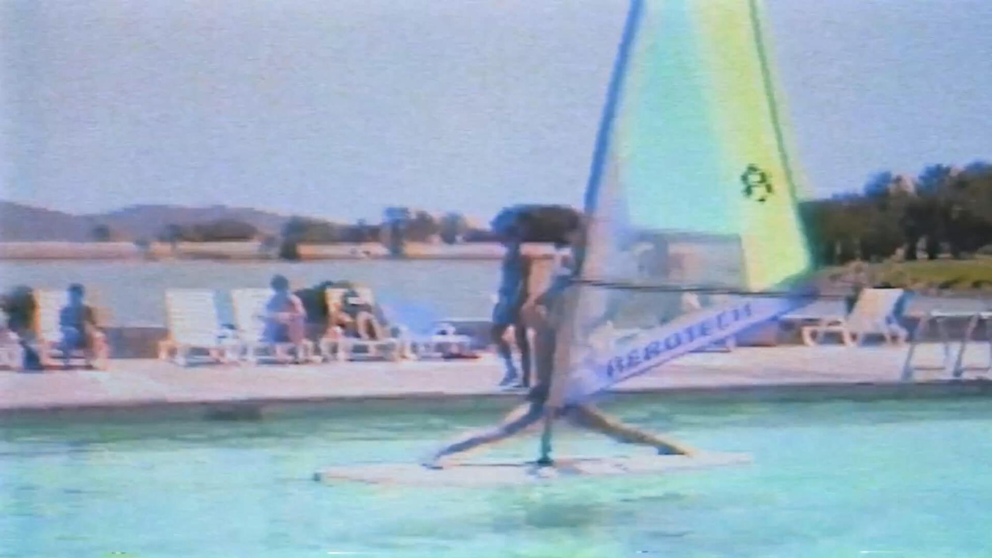 a man in a pool windsurfing